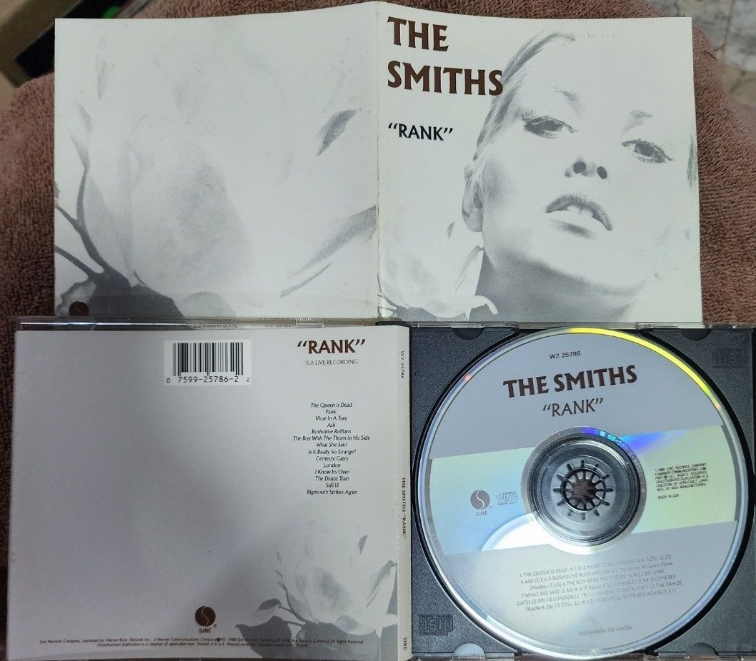 The Smiths - Rank (Category: CDs & DVDs) located in Cebu City. Submitted by g_roshamboo (Listing ID 1418575360, Image 2). Description: Smiths "Rank" CD. Includes the CD and the original booklet. The CD features tracks like "The Queen Is Dead", "Panic", and "What She Said". The album cover art is visible. The CD case is included..