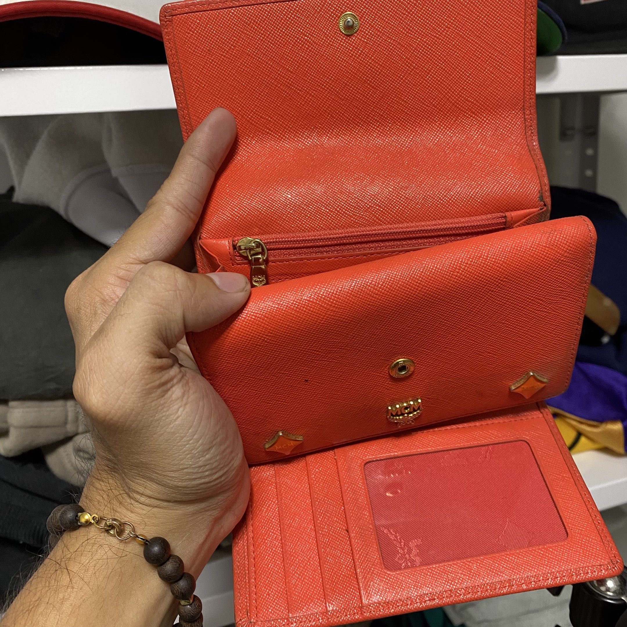 Vintage MCM studed charm trifold wallet (Category: Luxury Bags & Wallets) located in Imus. Submitted by fndsvntg_307 (Listing ID 1418441792, Image 2). Description: - Authentic MCM wallet - need cleaning - Vibrant orange color - Multiple card slots - Zippered coin compartment - Clear ID window - MCM logo on front and zipper pull - Secure snap closure - Fabric lining.