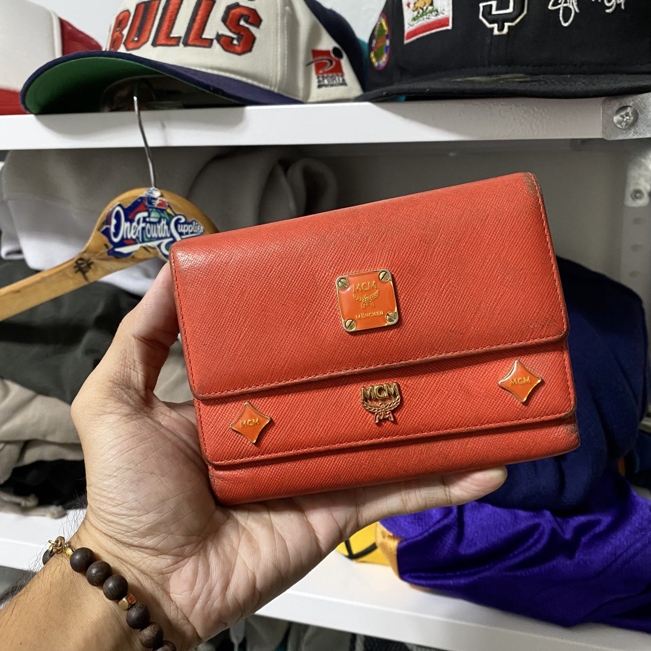Vintage MCM studed charm trifold wallet (Category: Luxury Bags & Wallets) located in Imus. Submitted by fndsvntg_307 (Listing ID 1418441792, Image 1). Description: - Authentic MCM wallet - need cleaning - Vibrant orange color - Multiple card slots - Zippered coin compartment - Clear ID window - MCM logo on front and zipper pull - Secure snap closure - Fabric lining.