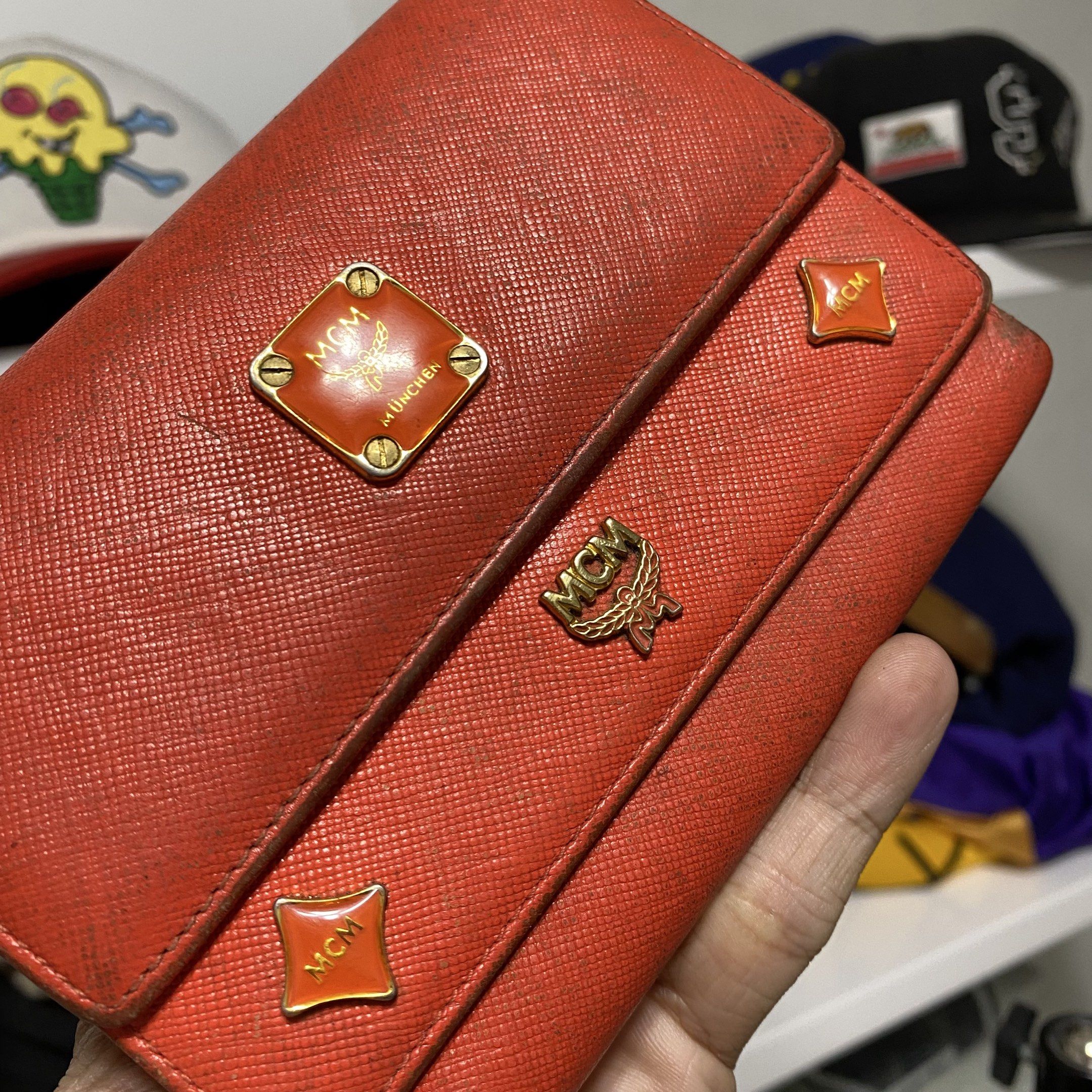 Vintage MCM studed charm trifold wallet (Category: Luxury Bags & Wallets) located in Imus. Submitted by fndsvntg_307 (Listing ID 1418441792, Image 3). Description: - Authentic MCM wallet - need cleaning - Vibrant orange color - Multiple card slots - Zippered coin compartment - Clear ID window - MCM logo on front and zipper pull - Secure snap closure - Fabric lining.