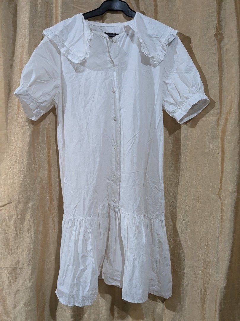White Dress with Peter Pan Collar (Category: Dresses) located in Quezon City. Submitted by stuff.decluttered (Listing ID 1418545834, Image 1). Description: - White dress - Peter Pan collar - Short sleeves - Button-down front - Ruffled hem - Lightweight fabric - Ideal for warm weather.