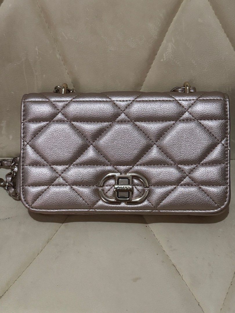 Aldo Quilted Chain Bag (Category: Luxury Bags & Wallets) located in Pasay City. Submitted by tanmaine22 (Listing ID 1413319898, Image 2). Description: - Aldo Sling Bag, convertible into Shoulder Bag and Pouch - Quilted design - Chain strap - Metallic finish - Rectangular shape - Flap closure with logo detail - Interior zippered pocket - Signs of wear on edges.