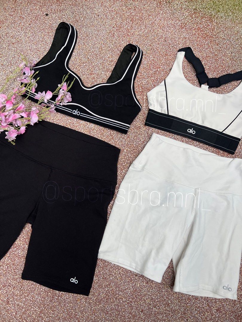 Alo Yoga Sports Bra and Shorts (Category: Activewear) located in Taguig. Submitted by sbmanilaaa (Listing ID 1413232398, Image 1). Description: - Alo activewear set - Includes: black sports bra (white trim), white sports bra (black straps), black shorts, white shorts - Supportive sports bra design - Biker short style shorts - Ideal for workouts and casual wear.