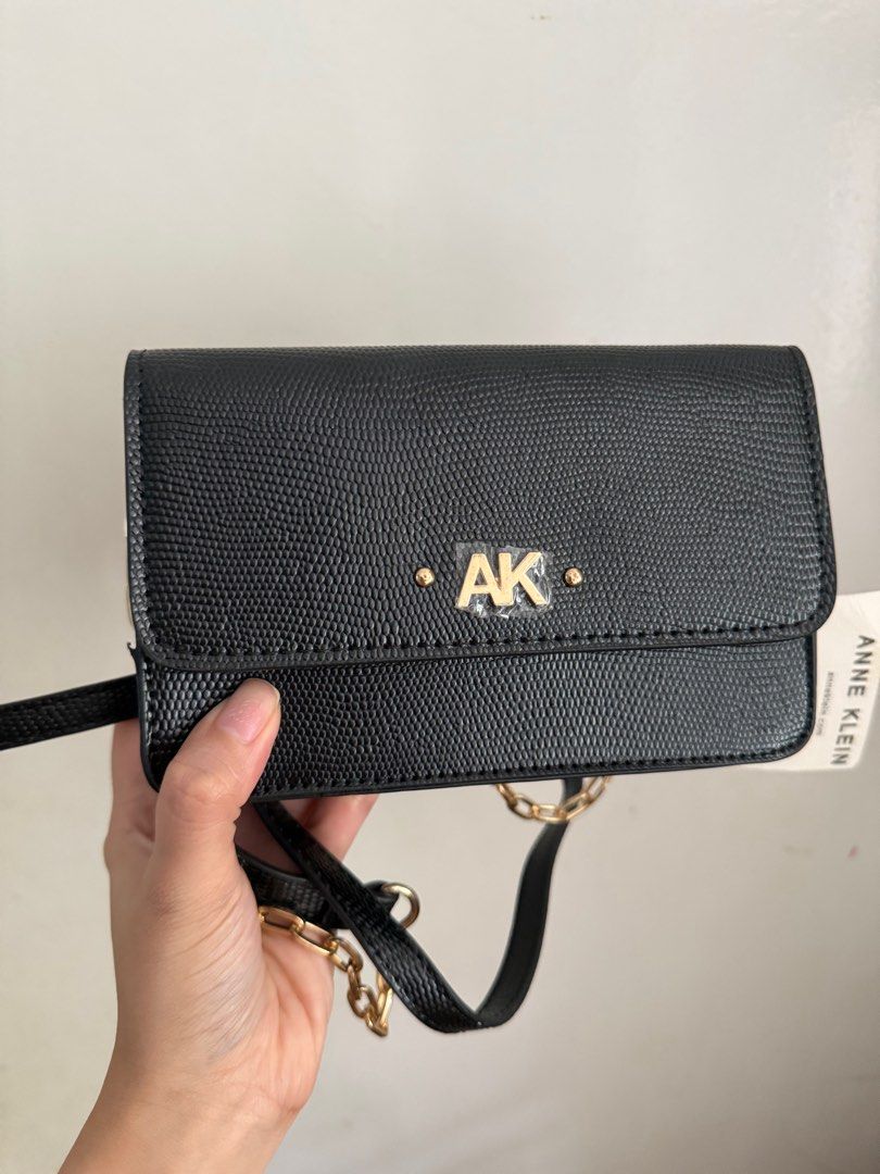Anne Klein Black Wallet on a Chain (Category: Luxury Bags & Wallets) located in Muntinlupa City. Submitted by marthapee (Listing ID 1413250977, Image 2). Description: - Anne Klein - Classic black color - Elegant gold chain strap - Features the iconic "AK" logo - Multiple interior compartments for organization - Includes a zippered exterion - Brand new with original tag attached - never been used.