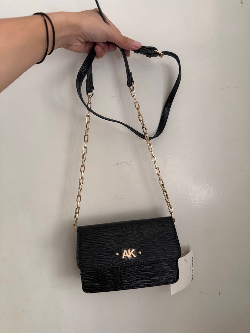 Anne Klein Black Wallet on a Chain (Category: Luxury Bags & Wallets) located in Muntinlupa City. Submitted by marthapee (Listing ID 1413250977, Image 1). Description: - Anne Klein - Classic black color - Elegant gold chain strap - Features the iconic "AK" logo - Multiple interior compartments for organization - Includes a zippered exterion - Brand new with original tag attached - never been used.