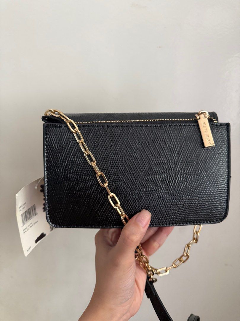 Anne Klein Black Wallet on a Chain (Category: Luxury Bags & Wallets) located in Muntinlupa City. Submitted by marthapee (Listing ID 1413250977, Image 3). Description: - Anne Klein - Classic black color - Elegant gold chain strap - Features the iconic "AK" logo - Multiple interior compartments for organization - Includes a zippered exterion - Brand new with original tag attached - never been used.