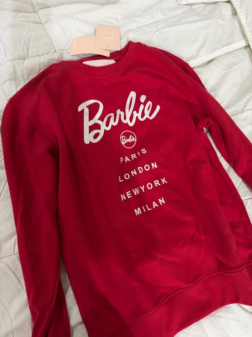 Barbie City Printed Sweatshirt - Red (Category: Longsleeves) located in Makati City. Submitted by prelovedclothes18 (Listing ID 1413362780, Image 1). Description: - Brand new Barbie City sweatshirt - Features the iconic Barbie logo - Includes city names: Paris, London, New York, Milan - Size: UK 06, EU 34, US 02, AUS 06 - New with original tags.