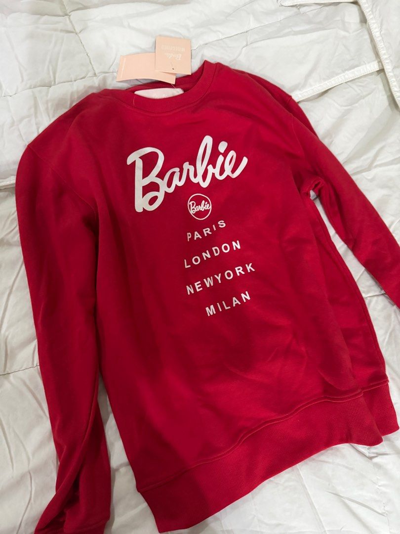 Barbie City Printed Sweatshirt - Red (Category: Longsleeves) located in Makati City. Submitted by prelovedclothes18 (Listing ID 1413362780, Image 2). Description: - Brand new Barbie City sweatshirt - Features the iconic Barbie logo - Includes city names: Paris, London, New York, Milan - Size: UK 06, EU 34, US 02, AUS 06 - New with original tags.