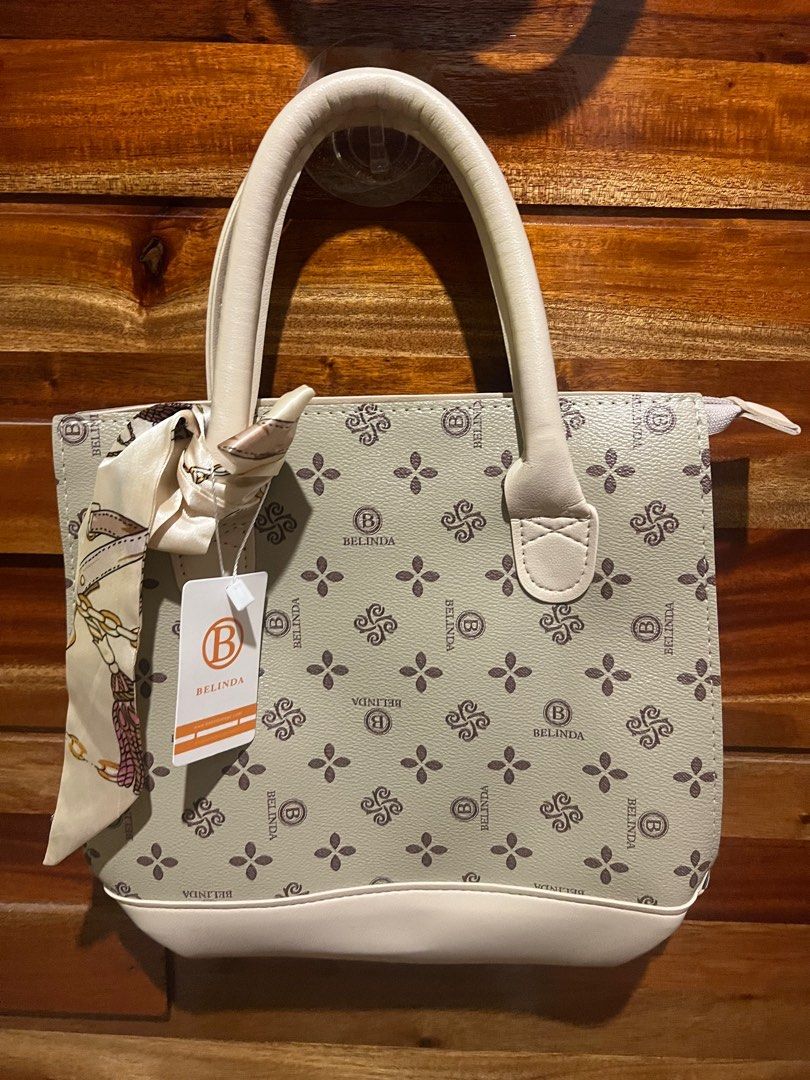 Belinda Tote Bag with Scarf (Category: Tote Bags) located in San Fernando. Submitted by jasminesibayan (Listing ID 1413386837, Image 1). Description: - Belinda tote bag - Patterned design - Matching scarf included - Top handle - Zipper closure - White base and handle - Brand name visible - Ideal for everyday use.