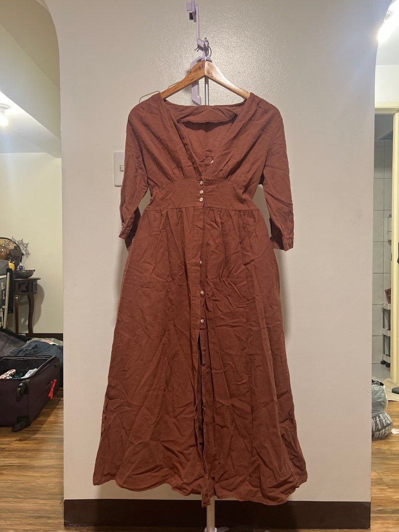Brown Button-Down Maxi Dress (Category: Dresses) located in Mandaluyong City. Submitted by faythemaker (Listing ID 1413339491, Image 1). Description: - Brown maxi dress - Button-down front - Flattering V-neck - Three-quarter sleeves - Pockets - Fitted waist - Full skirt - Subtle texture - Versatile for different occasions.