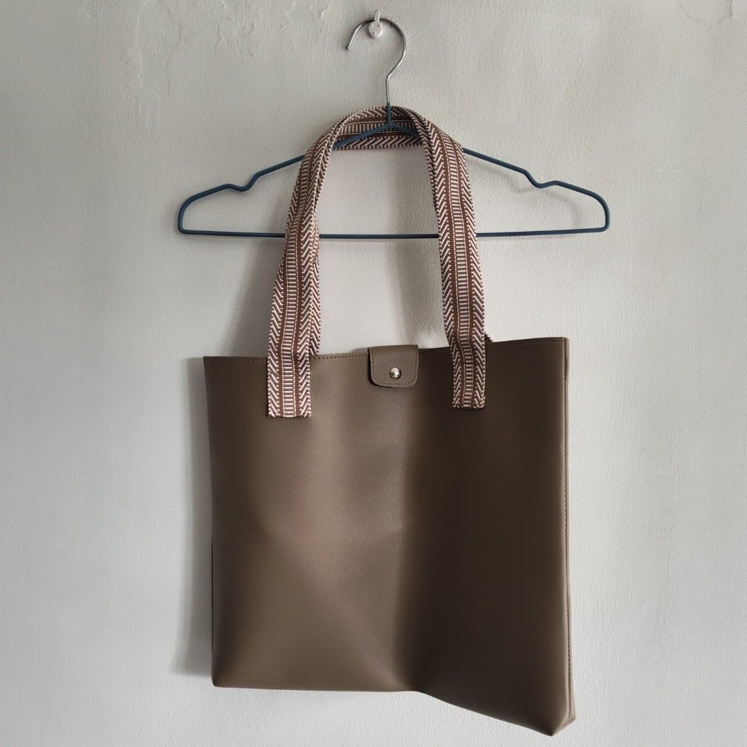 Brown Leather Tote Bag with Woven Straps (Category: Tote Bags) located in Imus. Submitted by decluttering_millennial (Listing ID 1413278742, Image 2). Description: Brown leather tote bag with woven straps. Flat tote bag Approx 12"H x 15"W. 9" strap drop. Good for everyday use. RFS: Never used..
