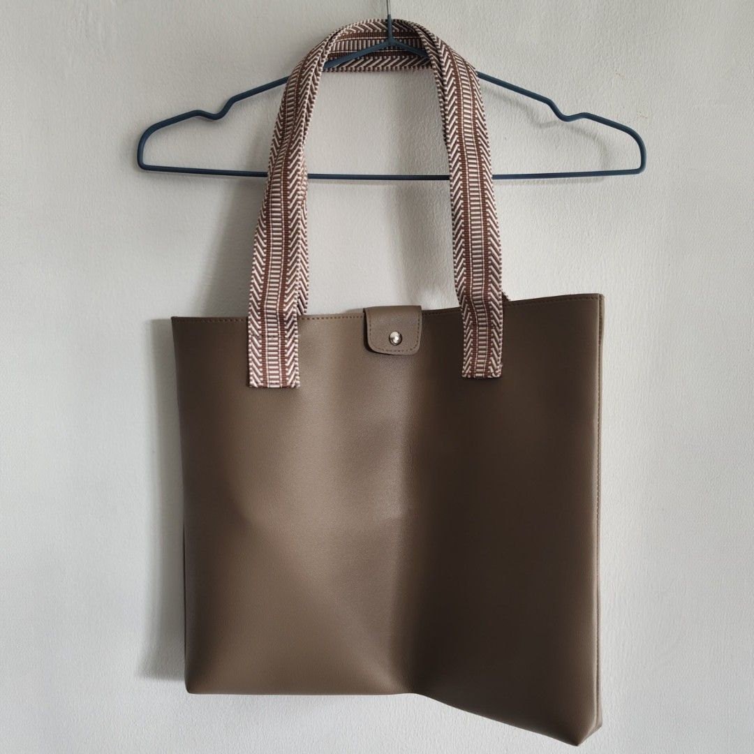 Brown Leather Tote Bag with Woven Straps (Category: Tote Bags) located in Imus. Submitted by decluttering_millennial (Listing ID 1413278742, Image 1). Description: Brown leather tote bag with woven straps. Flat tote bag Approx 12"H x 15"W. 9" strap drop. Good for everyday use. RFS: Never used..