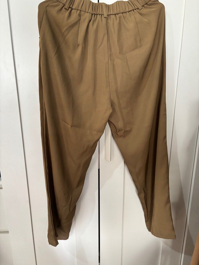 Brown Trousers with Elastic Waist (Category: Other Bottoms) located in Pasay City. Submitted by averycontent (Listing ID 1413278874, Image 2). Description: - Brown trousers - Elastic waistband for comfort - Straight leg cut - Side pockets - Smooth, woven fabric - Approximately 36 inches long.