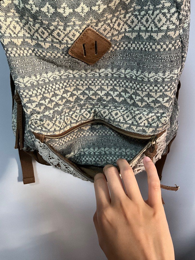 Claire's Patterned Backpack (Category: Backpacks) located in San Pedro. Submitted by dottable (Listing ID 1413434046, Image 3). Description: - Unique patterned design (reminiscent of 2010s) with lace detail - Adjustable straps and top handle - Multiple interior pockets - Includes a pocket with a Claire's label - Brown leather-like base and accents - Compact size, perfect for everyday use (13in in height).