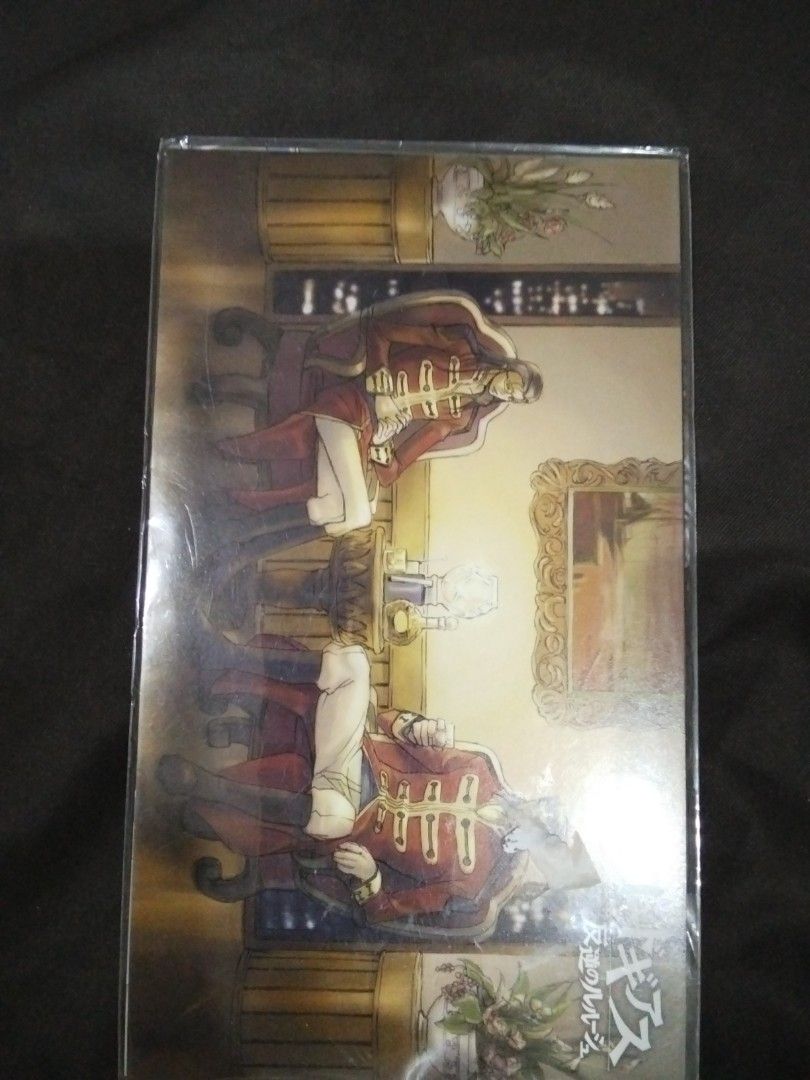 Code Geass Postcard Set (Category: Raw Singles) located in Santa Rosa. Submitted by animemerchcollection (Listing ID 1413330460, Image 2). Description: Set of Code Geass postcards. The set includes multiple postcards featuring different characters and scenes from the anime series. The postcards are in a sealed plastic packaging. The back of the packaging shows the Code Geass logo..