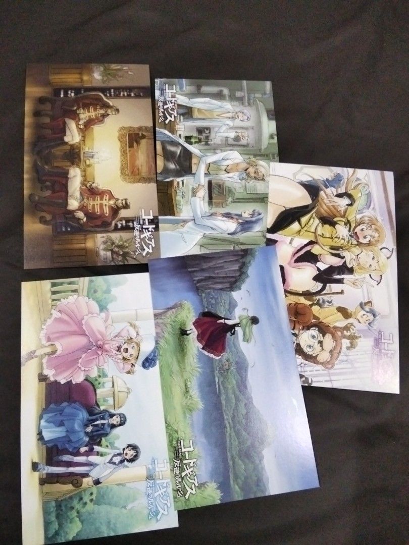 Code Geass Postcard Set (Category: Raw Singles) located in Santa Rosa. Submitted by animemerchcollection (Listing ID 1413330460, Image 1). Description: Set of Code Geass postcards. The set includes multiple postcards featuring different characters and scenes from the anime series. The postcards are in a sealed plastic packaging. The back of the packaging shows the Code Geass logo..
