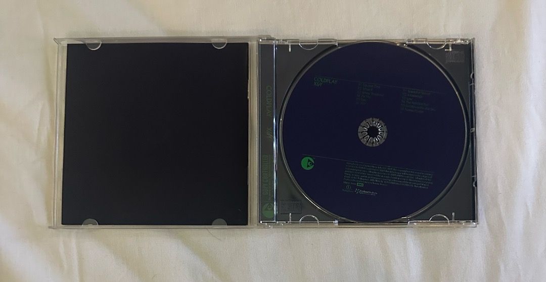 Coldplay X&Y CD (Category: CDs & DVDs) located in San Juan City. Submitted by looneybin559 (Listing ID 1413402179, Image 3). Description: - Coldplay "X&Y" CD for sale. - Features the iconic album art on a black case. - Includes the CD and case. - Tracklist includes "Square One", "Speed of Sound", and more. - CD is visible inside the case. Like New. Hard to Find CD. In Good Condition. WYSIWYG. ***ITEM IS AVAILABLE IF YOU CAN SEE THIS MESSAGE. Paym