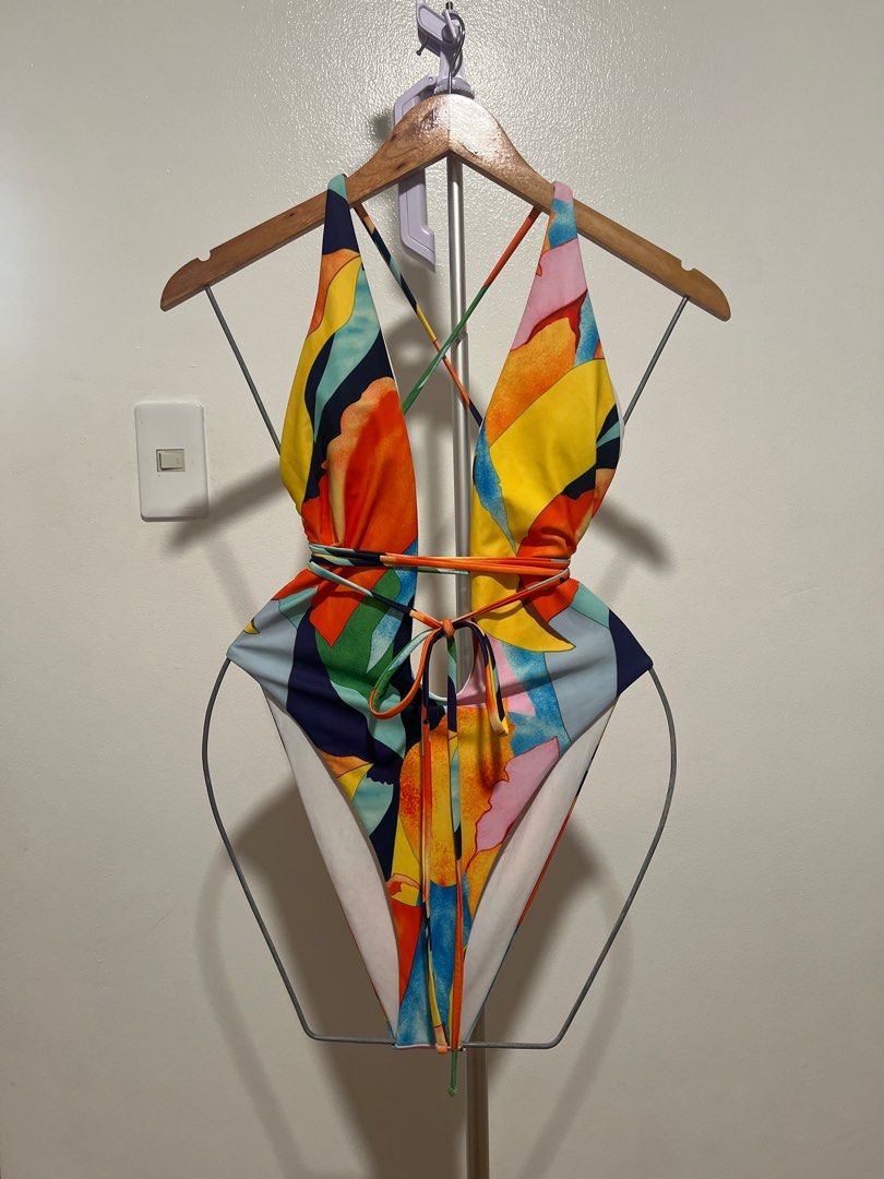 Colorful One-Piece Swimsuit (Category: Bikinis & Swimsuits) located in Mandaluyong City. Submitted by faythemaker (Listing ID 1413333740, Image 1). Description: Eye-catching one-piece swimsuit featuring a vibrant, abstract print. It has a halter neck design with criss-cross straps that you can customise to your needs. The swimsuit has a high-cut leg design. .