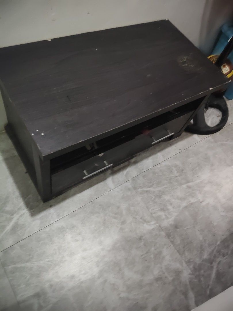 Dark Brown TV Stand with Drawers (Category: TV Consoles) located in Quezon City. Submitted by cherry018 (Listing ID 1413394005, Image 3). Description: - Dark brown wooden TV stand - Two drawers with silver handles - Open shelf for storage - Rectangular shape - Ideal for TVs - Provides storage for media devices.