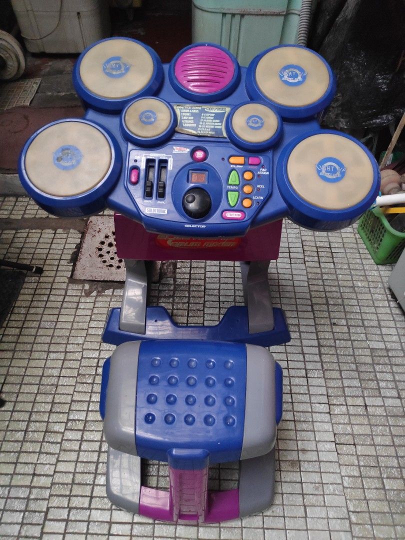 Electronic Drum Set (Category: Musical Instruments) located in Quezon City. Submitted by j.c.declutter (Listing ID 1413347033, Image 1). Description: - Electronic drum set for kids - Features multiple drum pads - Includes a control panel with various settings - Comes with a seat and stand - Colorful design: blue, pink, gray, and yellow - Ideal for children - Not sure if working.