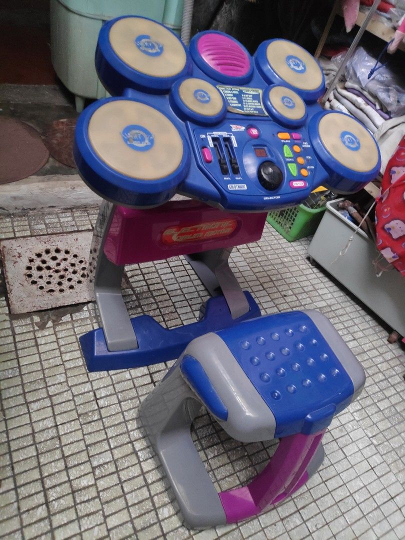 Electronic Drum Set (Category: Musical Instruments) located in Quezon City. Submitted by j.c.declutter (Listing ID 1413347033, Image 2). Description: - Electronic drum set for kids - Features multiple drum pads - Includes a control panel with various settings - Comes with a seat and stand - Colorful design: blue, pink, gray, and yellow - Ideal for children - Not sure if working.