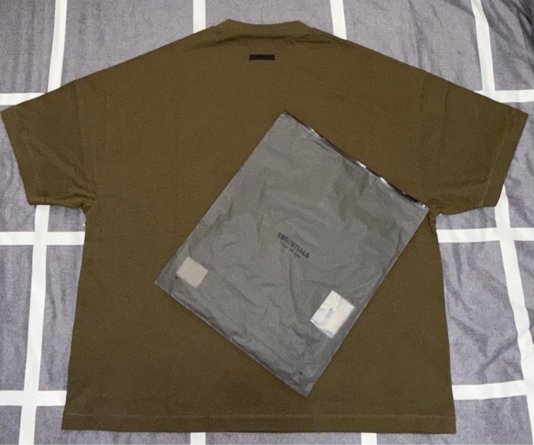 Fear of God Essentials Olive Green T-shirt (Category: Tshirts & Polo Shirts ) located in Quezon City. Submitted by ramearc (Listing ID 1413264851, Image 2). Description: - Fear of God Essentials T-shirt - Color: Olive - Size: L fits up to XXL (Super oversized) - Includes original tags and packaging - Original Price: 3,890 PHP - RFS : Wrong size and can’t be returned, with small oil stain.