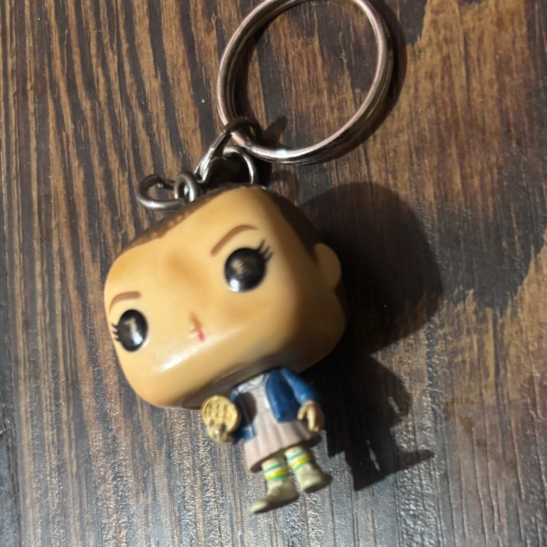 Funko Pop! Stranger Things Eleven Keychain (Category: Western Merchandise) located in Pasig City. Submitted by burtonxxx (Listing ID 1413239593, Image 2). Description: Funko Pop! Eleven keychain from Stranger Things. Features Eleven with a waffle, wearing her iconic outfit. Includes a silver keychain ring..