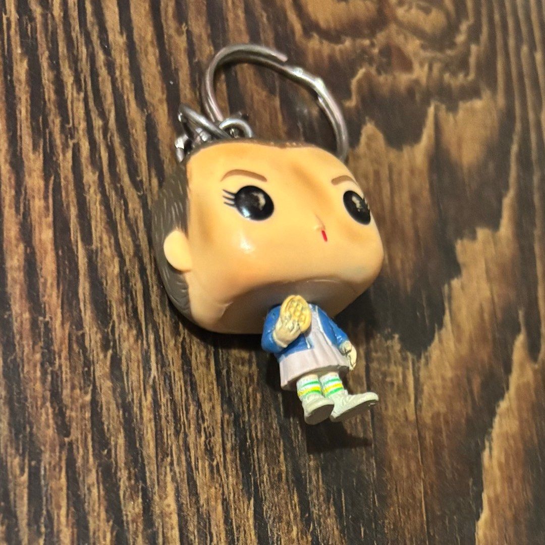 Funko Pop! Stranger Things Eleven Keychain (Category: Western Merchandise) located in Pasig City. Submitted by burtonxxx (Listing ID 1413239593, Image 3). Description: Funko Pop! Eleven keychain from Stranger Things. Features Eleven with a waffle, wearing her iconic outfit. Includes a silver keychain ring..