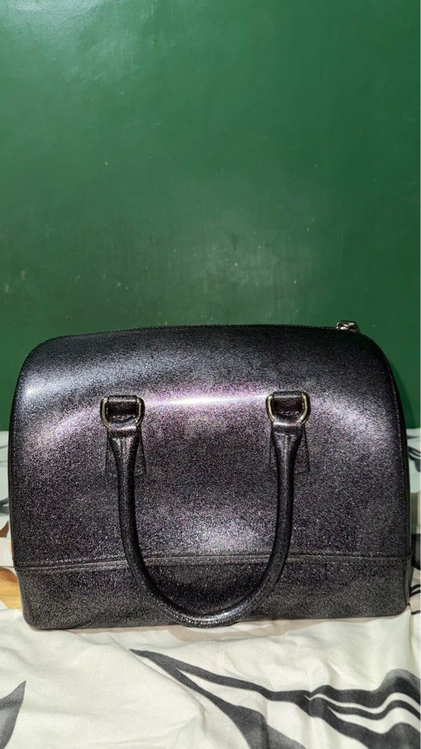 Furla Candy Satchel Bag (Category: Luxury Bags & Wallets) located in San Fernando. Submitted by wrda. (Listing ID 1413340470, Image 1). Description: - Furla Candy satchel bag - Zip closure - Double top handles - Glossy, glittery finish - Printed interior design - Dark color.