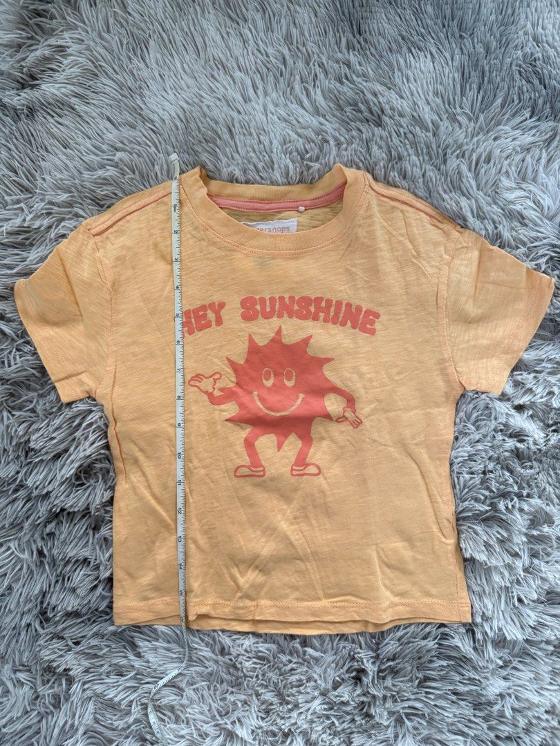 Gingersnaps Hey Sunshine T-shirt (Category: Babies & Kids Fashion) located in Muntinlupa City. Submitted by caistuff (Listing ID 1413383022, Image 2). Description: LAST PRICE POSTED ALREADY. - Gingersnaps t-shirt - Features a "Hey Sunshine" graphic - Size: 4Y - Color: Light orange - Design: Smiling sun graphic - Sleeves: Short - Neckline: Round - Material: Lightweight Measurements: - Length: 16 in - Width: 12.5 in.