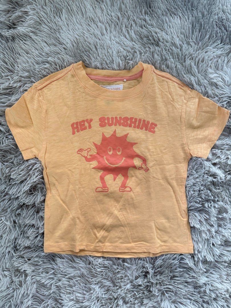Gingersnaps Hey Sunshine T-shirt (Category: Babies & Kids Fashion) located in Muntinlupa City. Submitted by caistuff (Listing ID 1413383022, Image 1). Description: LAST PRICE POSTED ALREADY. - Gingersnaps t-shirt - Features a "Hey Sunshine" graphic - Size: 4Y - Color: Light orange - Design: Smiling sun graphic - Sleeves: Short - Neckline: Round - Material: Lightweight Measurements: - Length: 16 in - Width: 12.5 in.