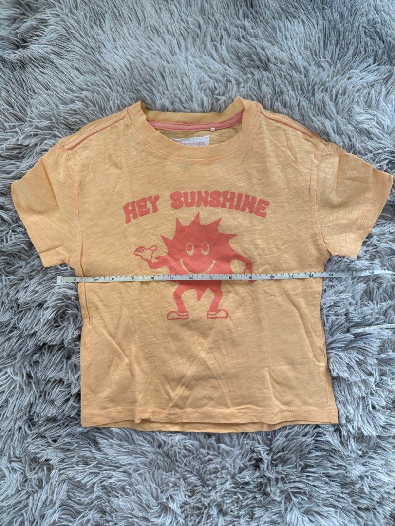 Gingersnaps Hey Sunshine T-shirt (Category: Babies & Kids Fashion) located in Muntinlupa City. Submitted by caistuff (Listing ID 1413383022, Image 3). Description: LAST PRICE POSTED ALREADY. - Gingersnaps t-shirt - Features a "Hey Sunshine" graphic - Size: 4Y - Color: Light orange - Design: Smiling sun graphic - Sleeves: Short - Neckline: Round - Material: Lightweight Measurements: - Length: 16 in - Width: 12.5 in.