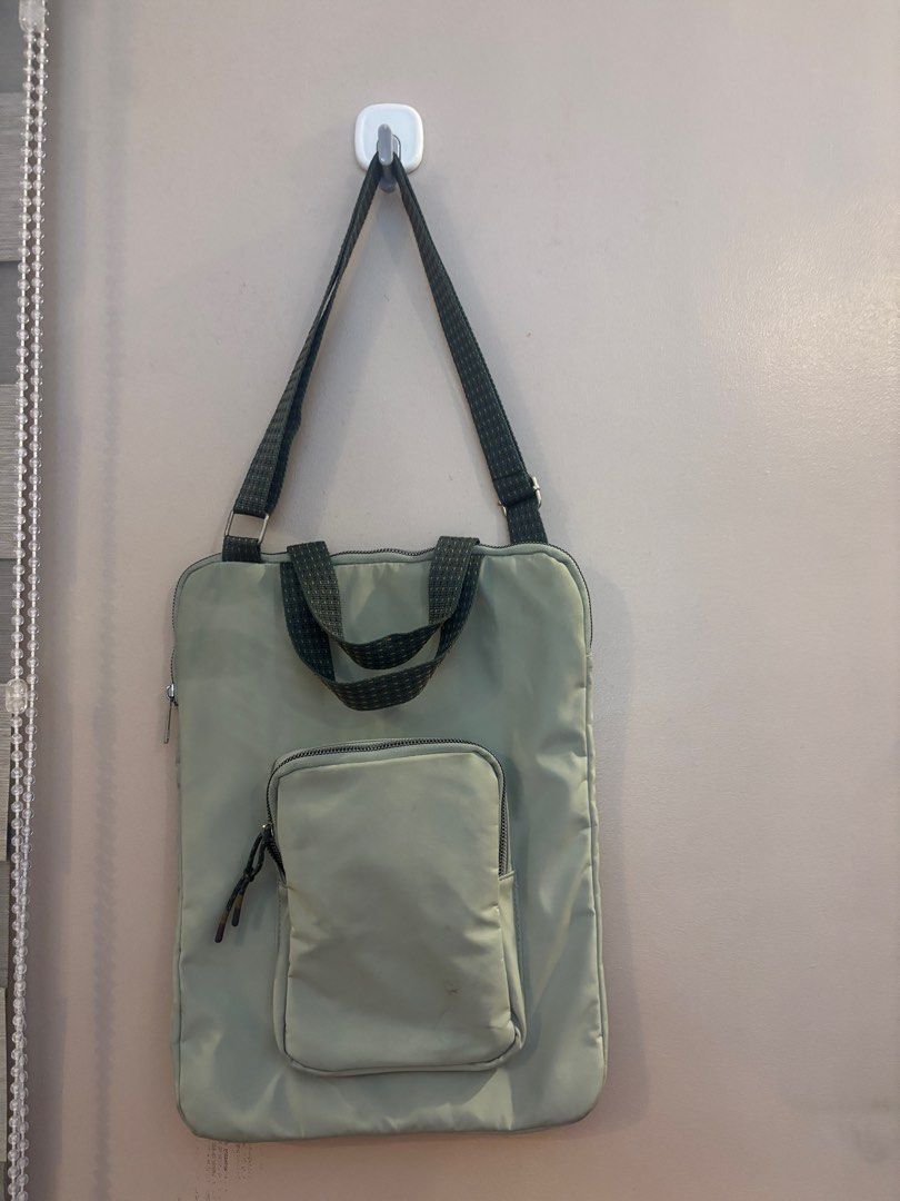 Green Tote Bag with Detachable Pouch (Category: Tote Bags) located in Manila. Submitted by coolwinddd (Listing ID 1413250828, Image 2). Description: - Stylish green tote bag - Detachable front pouch - Top handle and checkered shoulder strap - Zipper closure for main compartment and pouch - Made of durable, water-resistant material - Ideal for carrying essentials.