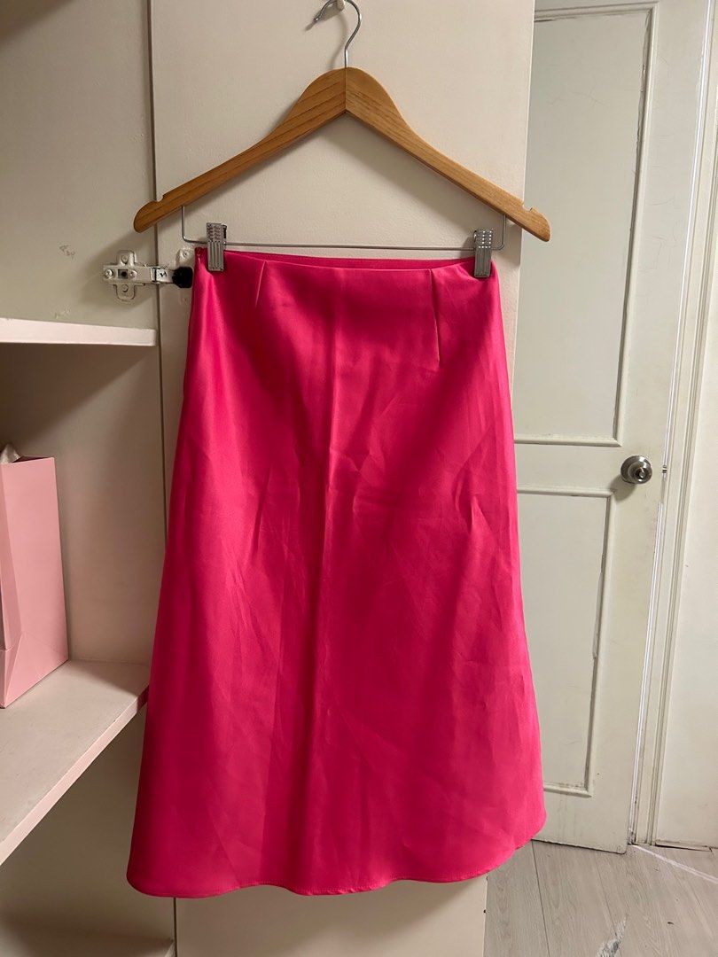 Hot Pink Satin Midi Skirt (Category: Skirts) located in San Juan City. Submitted by eloise___preloved (Listing ID 1413374481, Image 2). Description: - Smooth, shiny pink satin fabric - Midi length - Simple, elegant design - Straight cut, gently flares - Versatile for various outfits - TAKE ALL 3 SATIN MIDI SKIRTS LISTED ON MY PROFILE FOR 400 ❣️ 💳 MOP: GCASH 📦 MOD: j&t or ggx; SDD available via grab or lalamove.