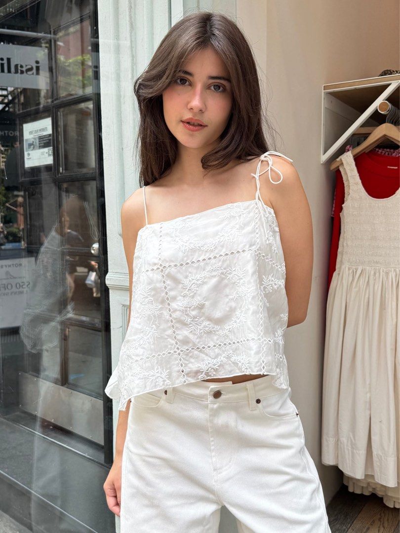 Isalis Cami White Embroidered Tank Spaghetti Top (Category: Sleeveless) located in Baguio. Submitted by sunbe4m (Listing ID 1413302716, Image 1). Description: - White tank top - Delicate embroidery - Square neckline - Adjustable spaghetti straps - Slightly asymmetrical hem - Lightweight fabric - Perfect for warm weather - Versatile style.