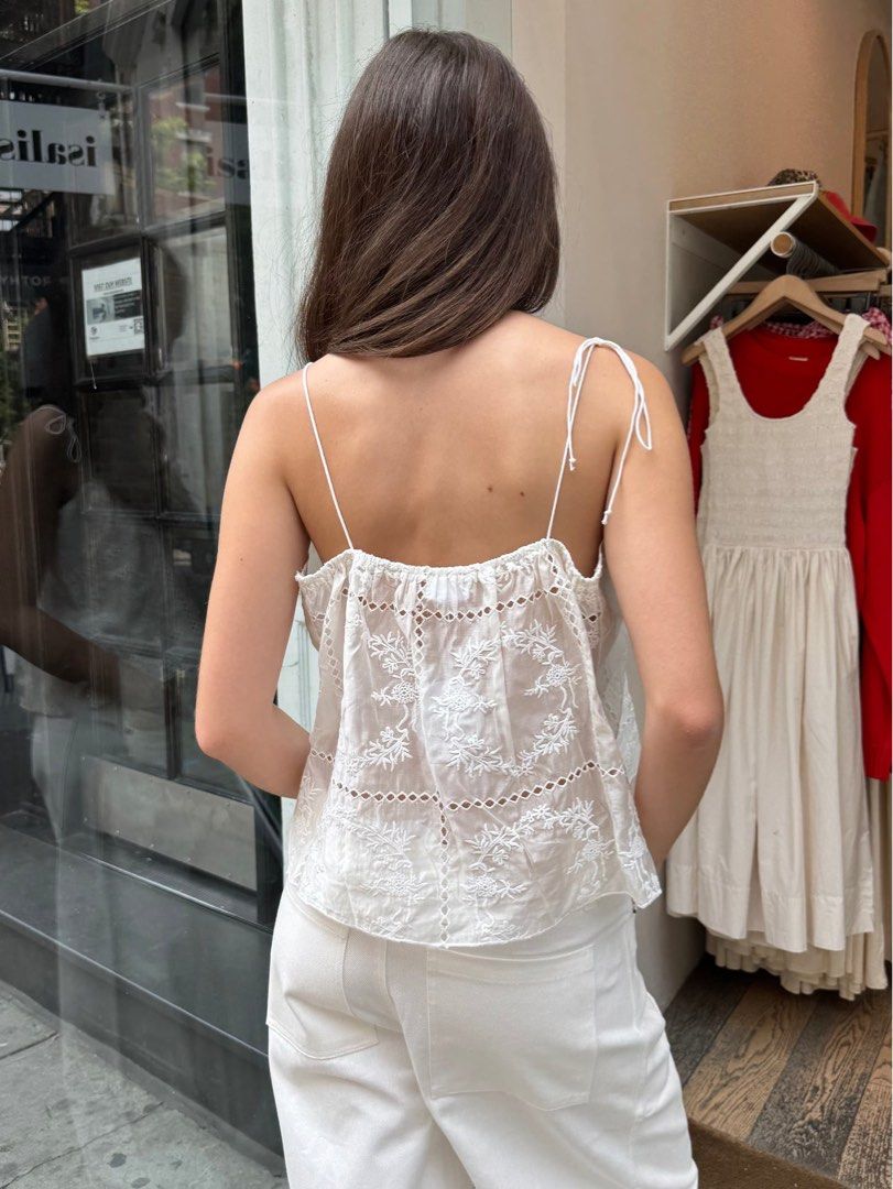Isalis Cami White Embroidered Tank Spaghetti Top (Category: Sleeveless) located in Baguio. Submitted by sunbe4m (Listing ID 1413302716, Image 3). Description: - White tank top - Delicate embroidery - Square neckline - Adjustable spaghetti straps - Slightly asymmetrical hem - Lightweight fabric - Perfect for warm weather - Versatile style.