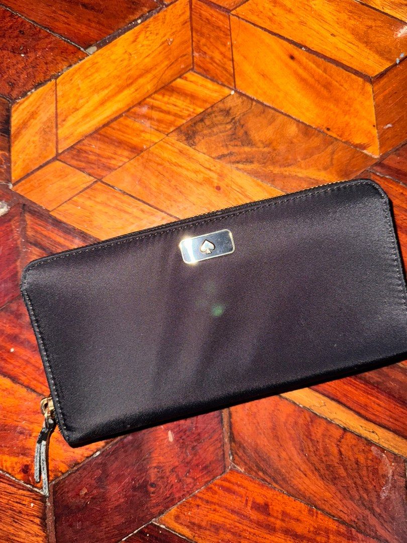 Kate Spade Long Black Nylon Wallet (AUTHENTIC) (Category: Luxury Bags & Wallets) located in Quezon City. Submitted by jellyaceeyoo (Listing ID 1413403790, Image 1). Description: •Price is slightly negotiable •Minor flaw only on the zipper • Green dot on the cloth is just a reflection from camera flash •Will not send more pictures in chat as details can be seen in the listing •Payment: GCash •Delivery: Same-day delivery/ Courier.