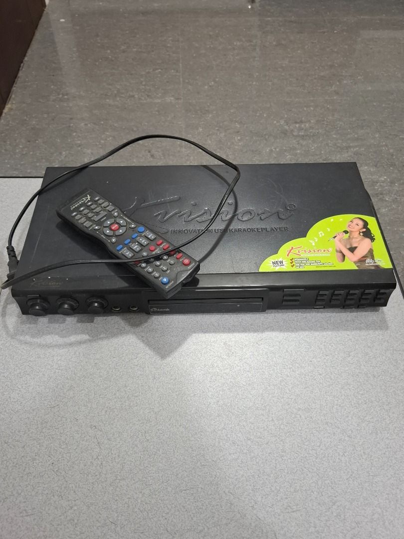 Krisvision Karaoke Player with Remote (Category: Portable Music Players) located in Caloocan City. Submitted by lianahmend48152 (Listing ID 1413326296, Image 1). Description: Krisvision karaoke player comes with a remote control. It has various input jacks and control knobs on the front panel. The player features a disc tray and a display panel. Perfect for home entertainment and karaoke nights..