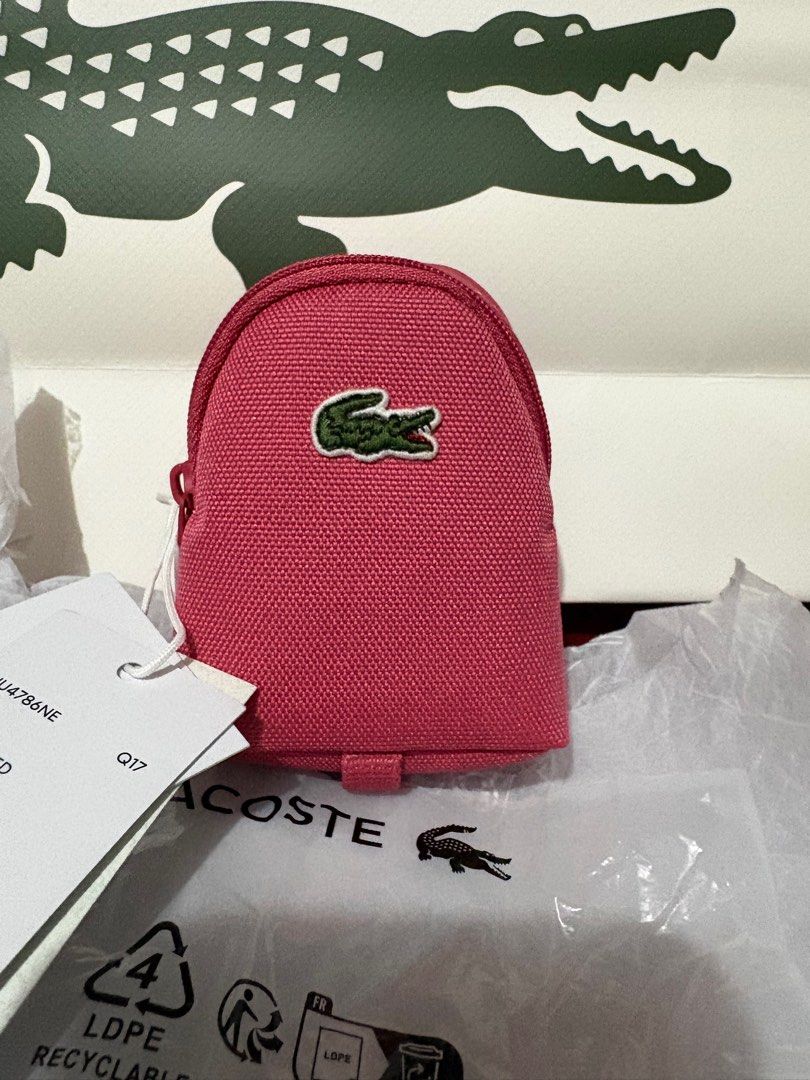 Lacoste Claret Red Coin Purse (Category: Purses & Pouches) located in Cavite. Submitted by ladyrain21 (Listing ID 1413227418, Image 2). Description: - Authentic Lacoste coin purse - Color: Claret red - Features the iconic Lacoste crocodile logo - Material: 100% polyester - Comes with original tags and packaging - Original price: P1,950.00 - Ideal for coins and small essentials - Compact and stylish design.