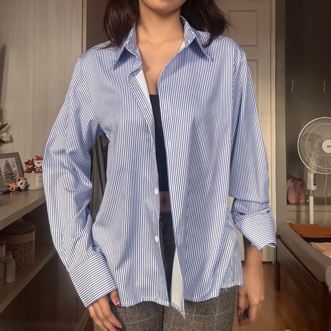 Blue Striped Oversized Shirt (Category: Shirts) located in Quezon City. Submitted by kaeshops (Listing ID 1413364877, Image 1). Description: Decluttering my preloved clothes! PM me for more photos 🩷 items are negotiable if buying multiple items! Can do meet-ups or ship from Diliman, QC or Sampaloc, Manila - Oversized fit - Blue vertical stripes - Classic collar - Button-down closure - Long sleeves with buttoned cuffs - Lightweight fabric - Suita