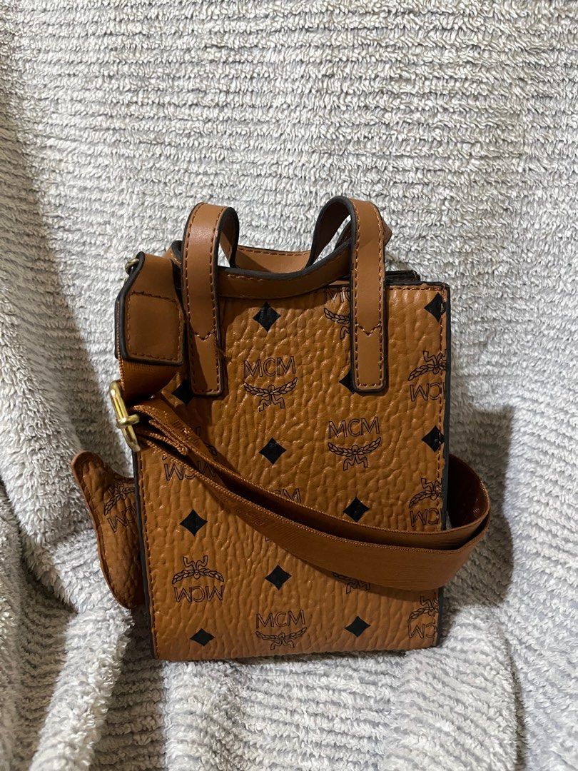 MCM Mini Bag with Dog Charm (two way bag) (Category: Luxury Bags & Wallets) located in Tarlac. Submitted by graavvyyy (Listing ID 1413261535, Image 2). Description: - MCM mini bag - Signature Visetos print - Detachable dog charm - Top handle - Detachable shoulder strap - Includes dust bag - MCM logo and design elements.