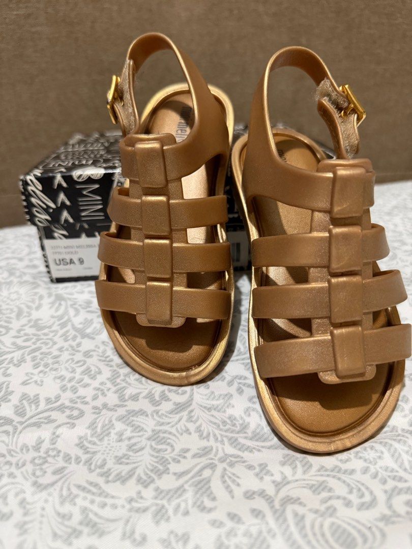 Mini Melissa Flox Shine BB Gold Sandals (Category: Babies & Kids Fashion) located in Makati City. Submitted by rhen00 (Listing ID 1413246671, Image 1). Description: - Mini Melissa Flox Shine BB sandals - Color: Gold - Size: USA 9 - Features: Buckle closure, woven design - Includes original box - Made in Brazil.