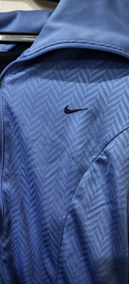 Nike Blue Zip-Up Jacket (Category: Coats, Jackets and Outerwear) located in Quezon City. Submitted by jonree (Listing ID 1413329261, Image 1). Description: - Blue Nike zip-up jacket - Textured pattern - Small Nike logo on chest - Full-length zipper - Collar - Black stripes on sleeves - Fitted style - Dark blue lining.