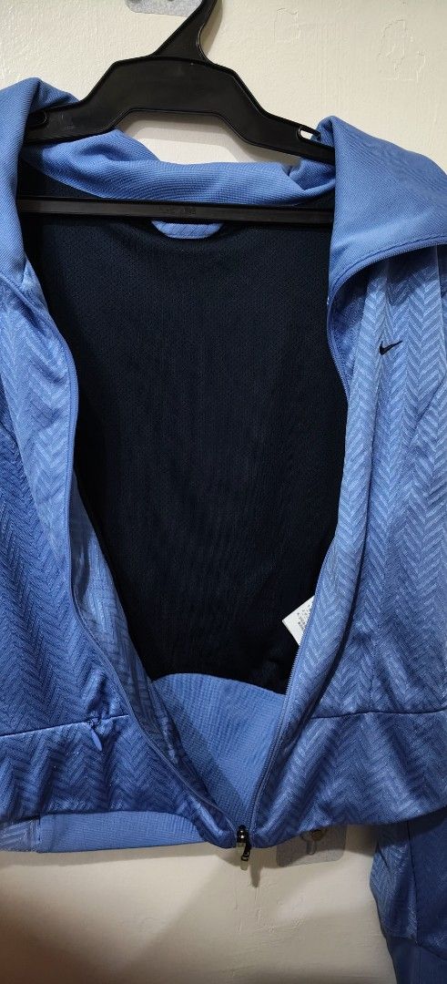 Nike Blue Zip-Up Jacket (Category: Coats, Jackets and Outerwear) located in Quezon City. Submitted by jonree (Listing ID 1413329261, Image 3). Description: - Blue Nike zip-up jacket - Textured pattern - Small Nike logo on chest - Full-length zipper - Collar - Black stripes on sleeves - Fitted style - Dark blue lining.