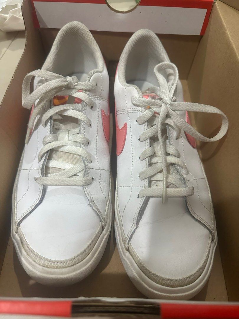 Nike Court Royale Sneakers (Category: Sneakers) located in Manila. Submitted by coco041516 (Listing ID 1413426053, Image 1). Description: - White Nike Court Royale sneakers - Pink swooshes and heel tabs - White soles with orange stripe - Pink insoles - Comes with original box Women size US 9 / 7y men .