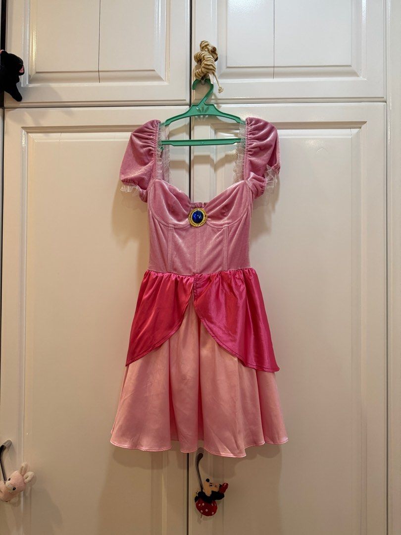 Princess Peach Costume (Category: Dresses) located in Cebu City. Submitted by jar1997 (Listing ID 1413357126, Image 2). Description: - Princess Peach costume - Pink velvet bodice with jewel detail - Puff sleeves - Layered skirt - Includes matching choker - Includes crown - Ideal for cosplay and themed events Bought for $80, used ONCE only.
