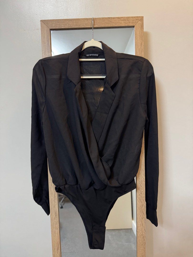 Terranova XS Black Bodysuit (Category: Others Tops) located in Makati City. Submitted by sphpnd (Listing ID 1413282064, Image 1). Description: - Terranova black bodysuit - Collared, wrap-style front - Long sleeves with buttoned cuffs - Snap closures at the bottom - Size: XS.