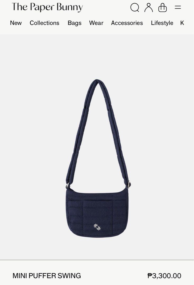The Paper Bunny Navy Handbag (Category: Tote Bags) located in Malabon City. Submitted by shopnipau (Listing ID 1413338941, Image 3). Description: - The Paper Bunny navy handbag - Quilted design - Features a small decorative detail - Charm not included - Includes a matching paper bag - Top handle and shoulder strap.