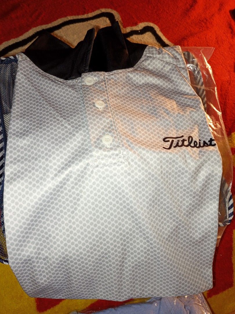 Titleist Golf Shirt (Category: Golf) located in Manila. Submitted by mysteriousjohnny (Listing ID 1413235387, Image 2). Description: - Brand new Titleist golf shirt - Stylish white and gray patterned design - Features a classic button-down front - Includes a practical chest pocket - Accented with black details on sleeves and hem - Still in original packaging - Size Large - Cool dry.
