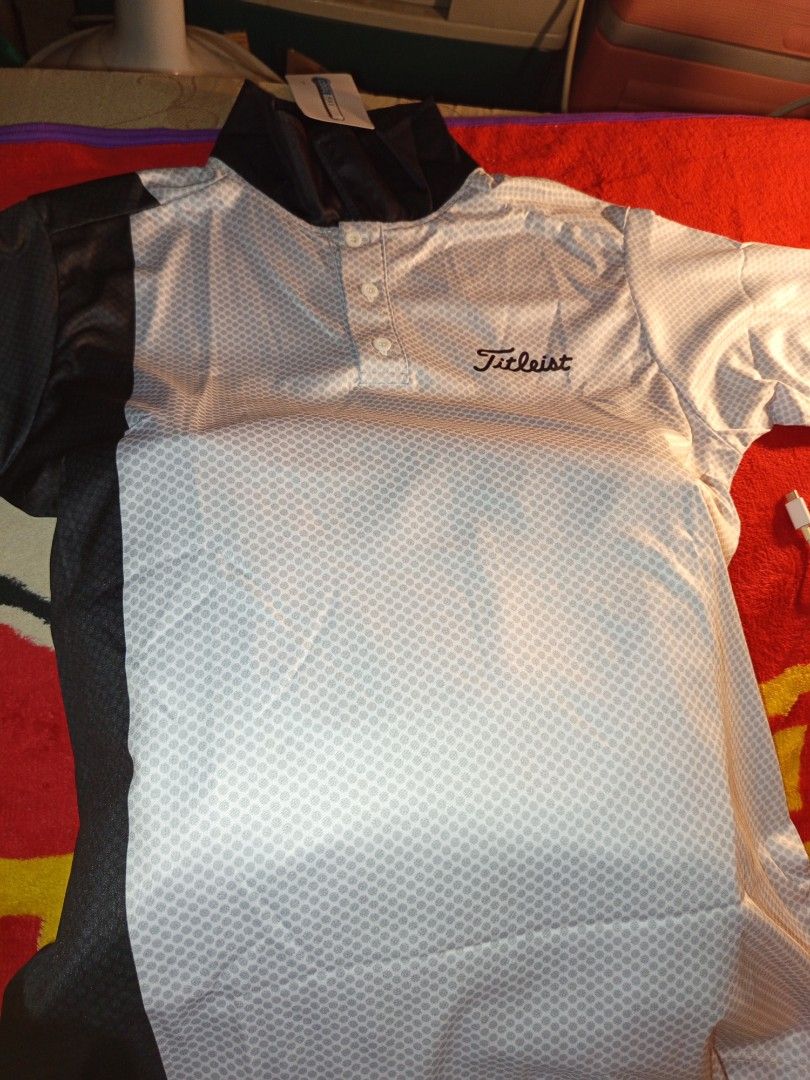 Titleist Golf Shirt (Category: Golf) located in Manila. Submitted by mysteriousjohnny (Listing ID 1413235387, Image 1). Description: - Brand new Titleist golf shirt - Stylish white and gray patterned design - Features a classic button-down front - Includes a practical chest pocket - Accented with black details on sleeves and hem - Still in original packaging - Size Large - Cool dry.